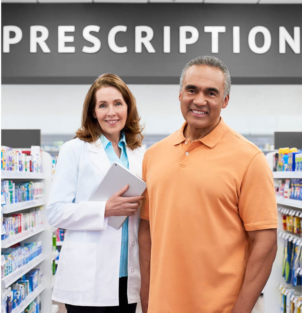 Our pharmacist with a patient at the prescription counter